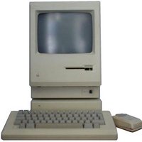 Probably an original Apple Macintosh.  Flat base unit, monitor with floppy drive under the screen, chunky keyboard and mouse.