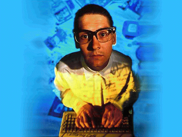 An insultingly nerdy looking guy using a keyboard