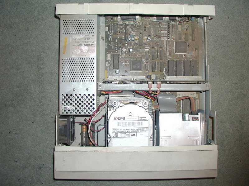 The base unit with the lid off, showing a dusty motherboard