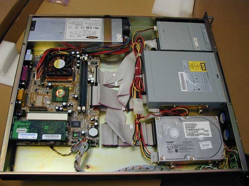 The insides of the 1U server, showing the original floppy drive, CD ROM drive, and hard drive.