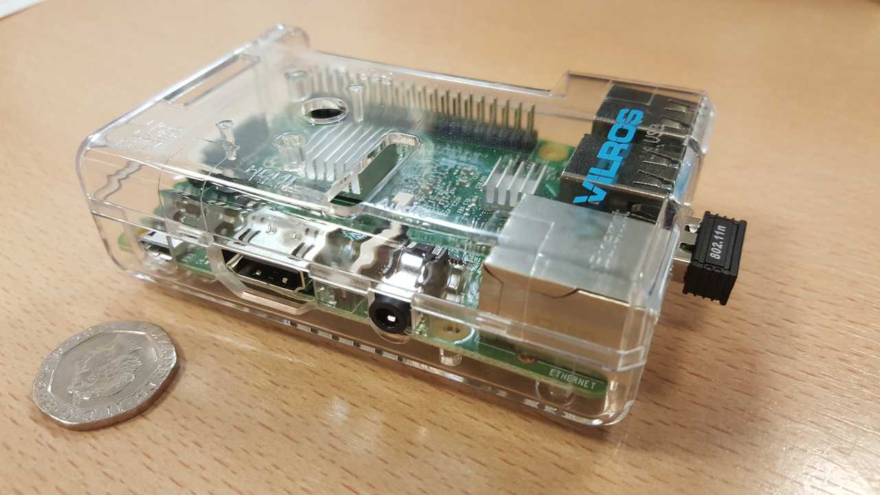 A tiny Raspberry Pi computer next to a 20p piece for size reference