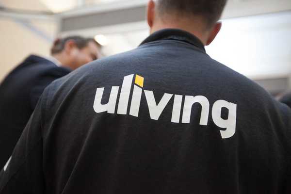 Someone's back, who is wearing a Uliving sweatshirt with the logo between the shoulder blades.